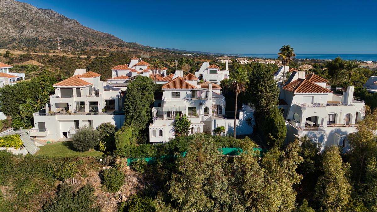 Aerial view of hillside villas with the sea beyond