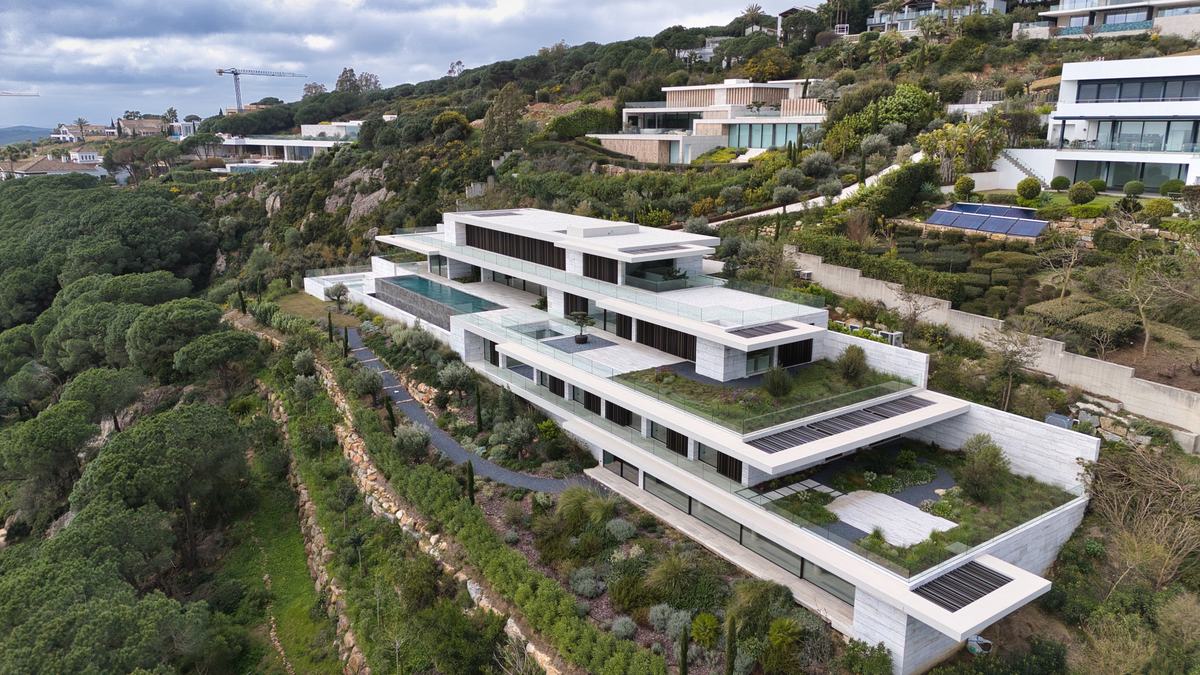 Aerial view of a contemporary terraced villa on a hillside