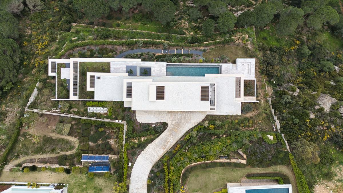 Overhead view of the terraced hillside villa and its approach
