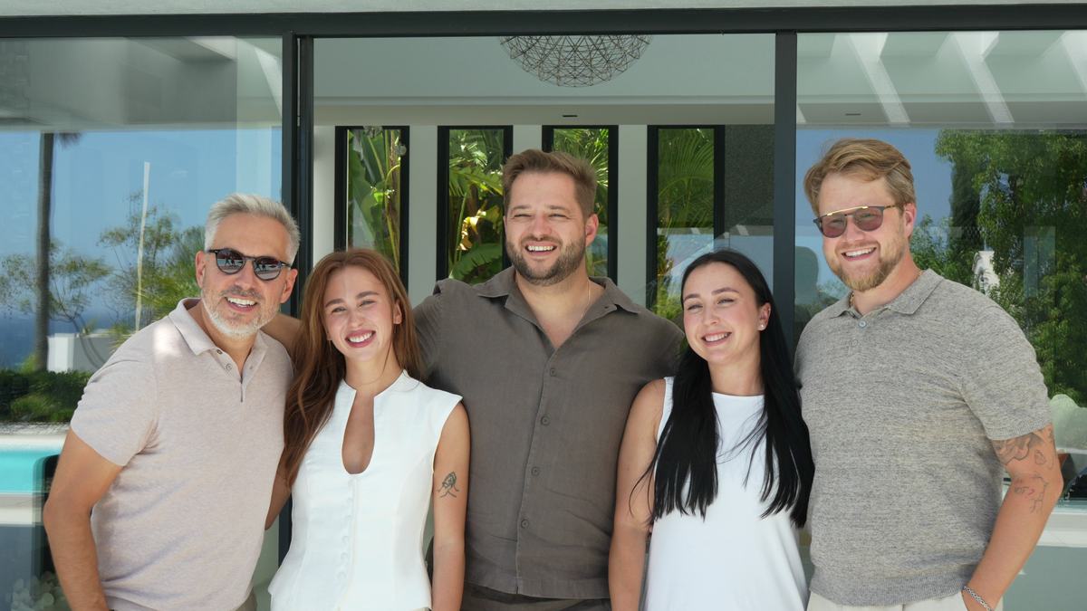 Five members of an agency team outside a contemporary villa