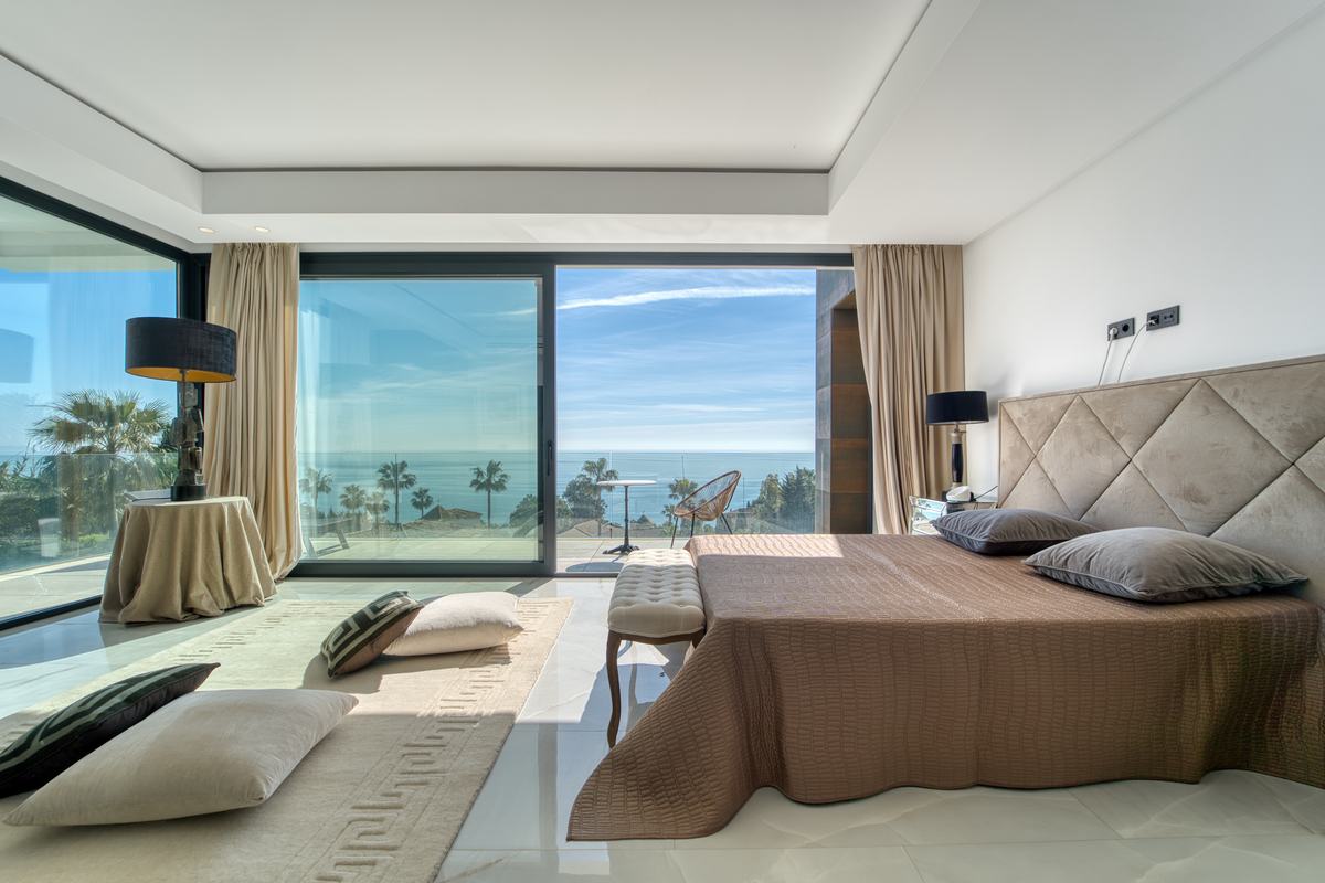 Principal bedroom with floor-to-ceiling glazing and sea view