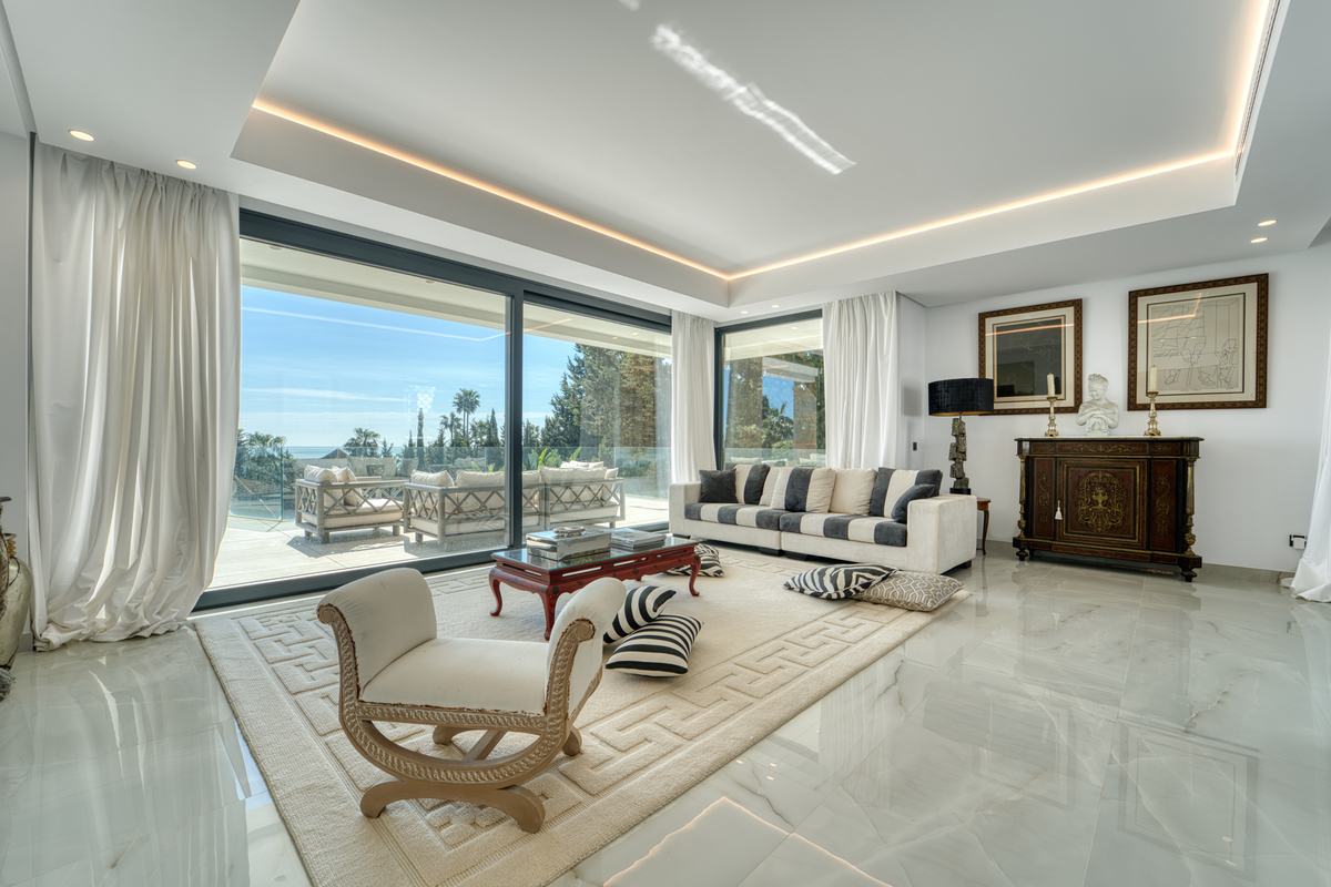 Living room opening onto a terrace with sea view