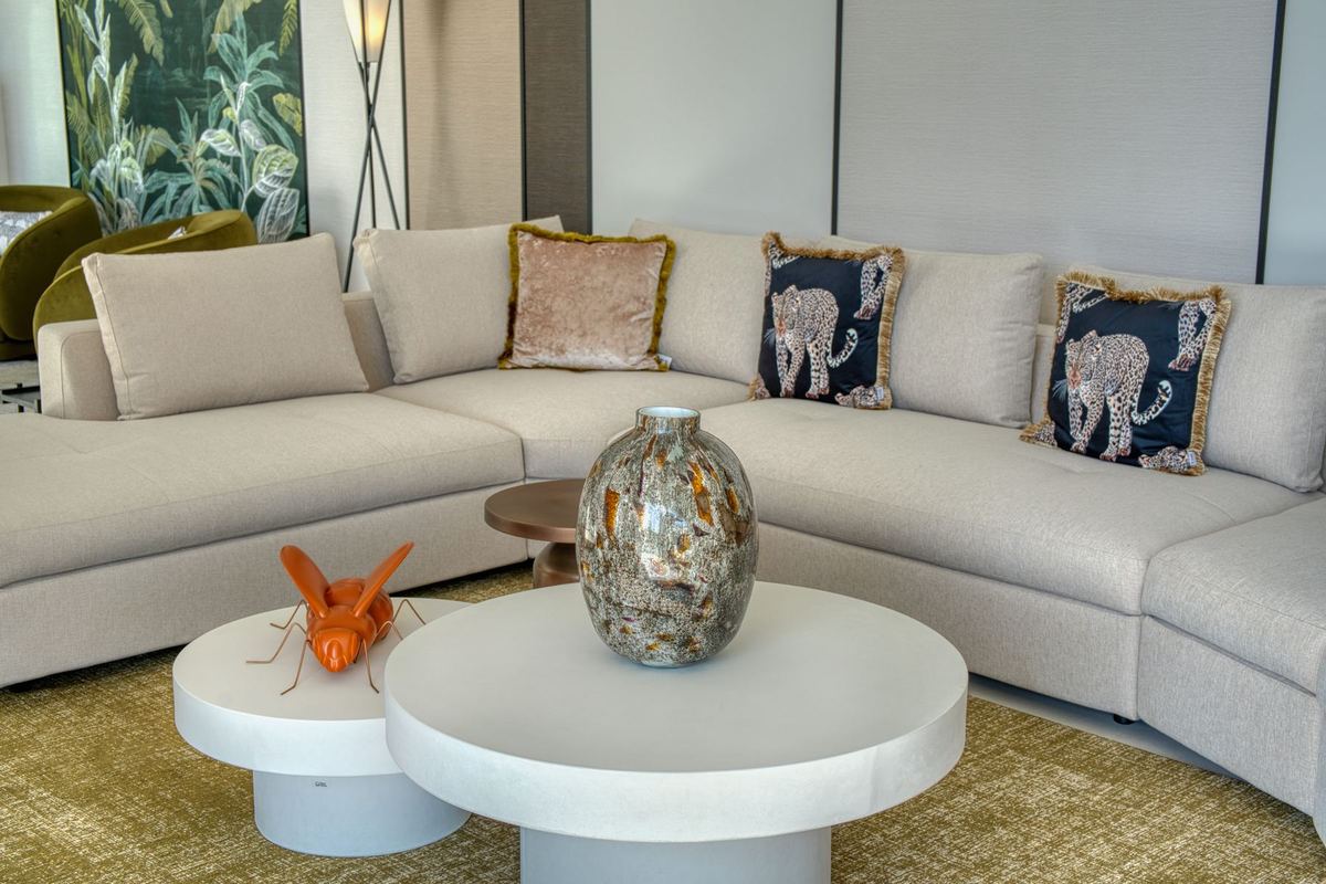 Detail of a cream sectional sofa and low tables