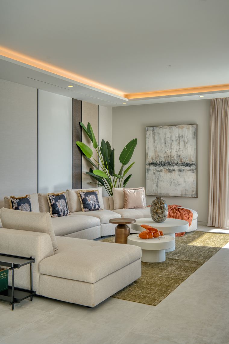 Living room with cream sectional and large abstract artwork